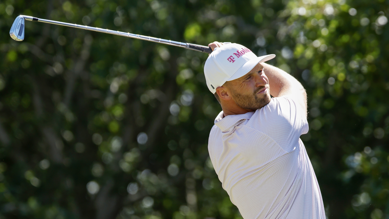 Wyndham Clark hits an approach shot into the green