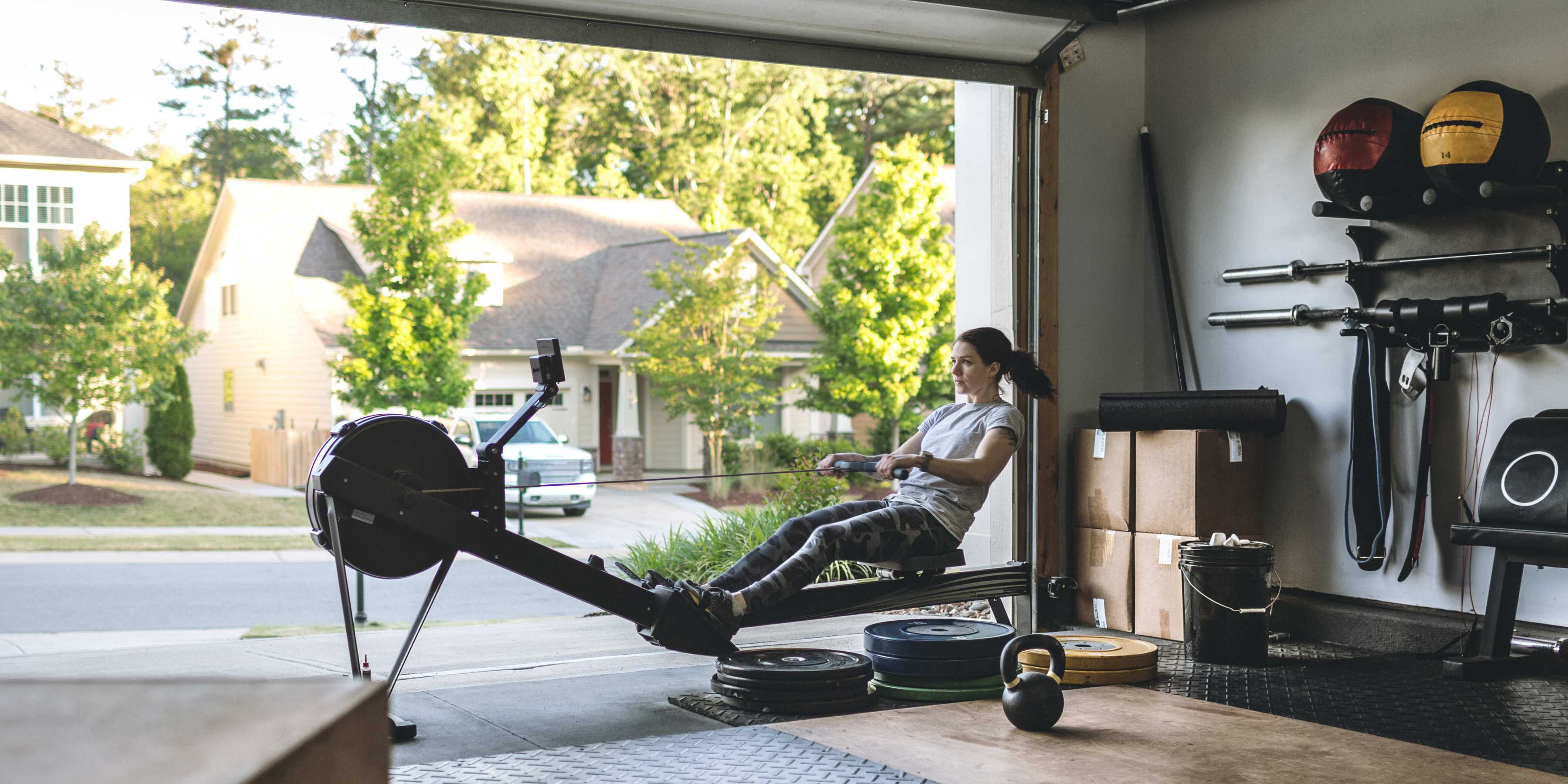 Image of woman using a rowing machine at home