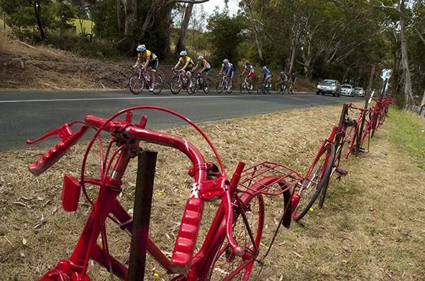 Riders head past a display of bikes over the top of Mt.Buninyong