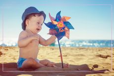 Baby in the shade on a beach