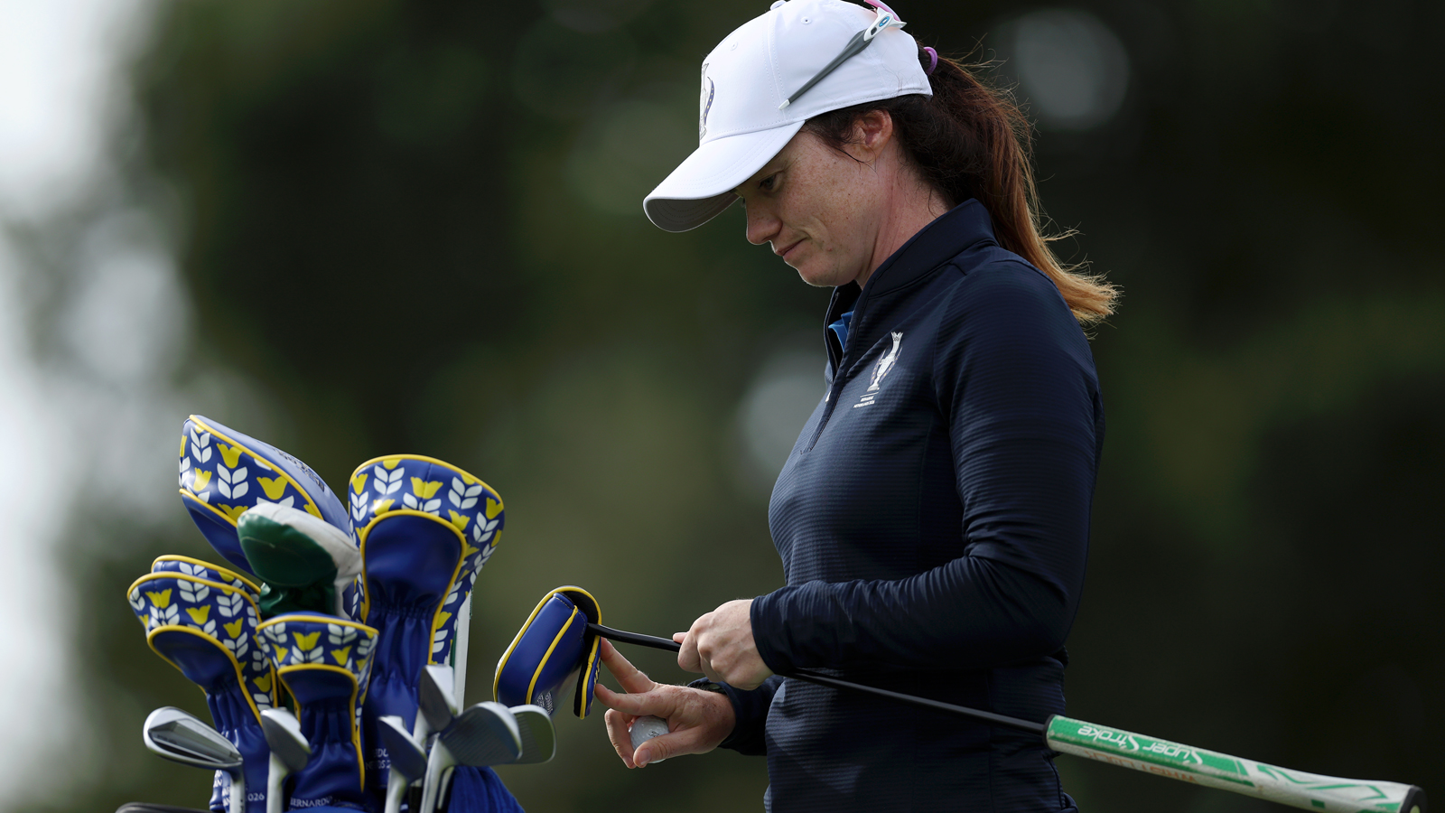 Leona Maguire looks down at her golf bag