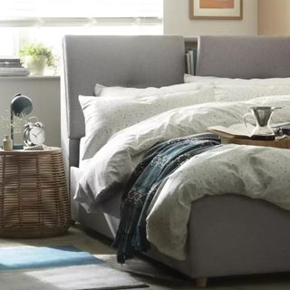 Bed frame with storage in the headboard