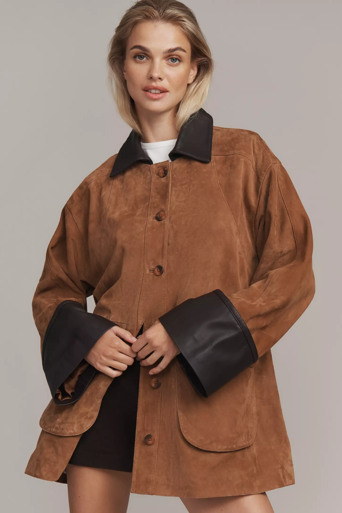 a model wears a suede barn jacket from anthropologie