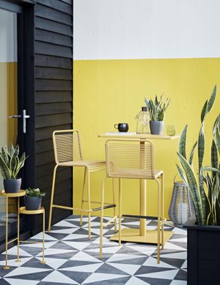 small garden layout ideas: yellow wall and seating area Habitat