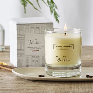 An orange scented candle - best Christmas scents