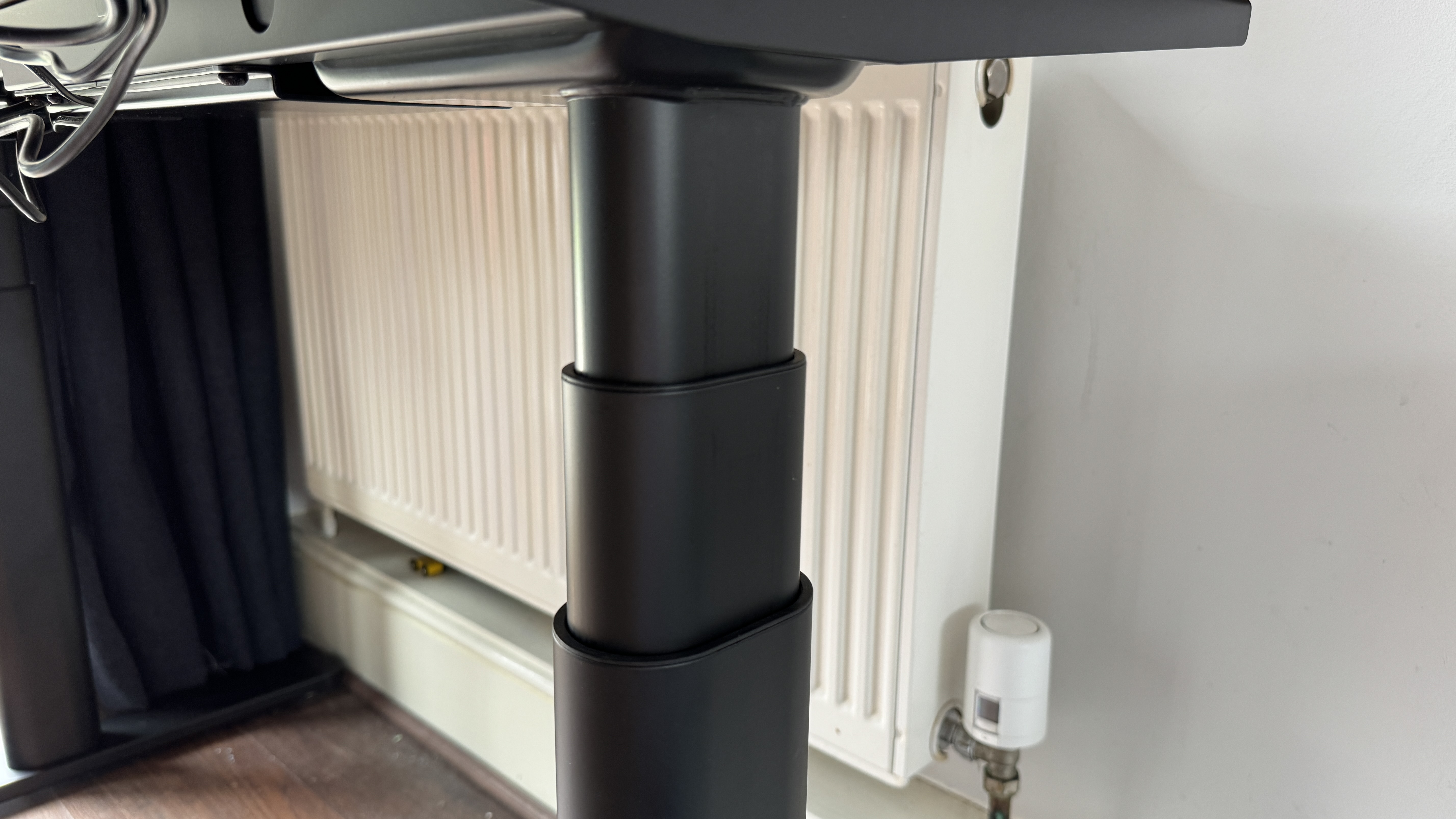 A brown wooden Maidesite TH2 Pro Plus desk in a bright home office