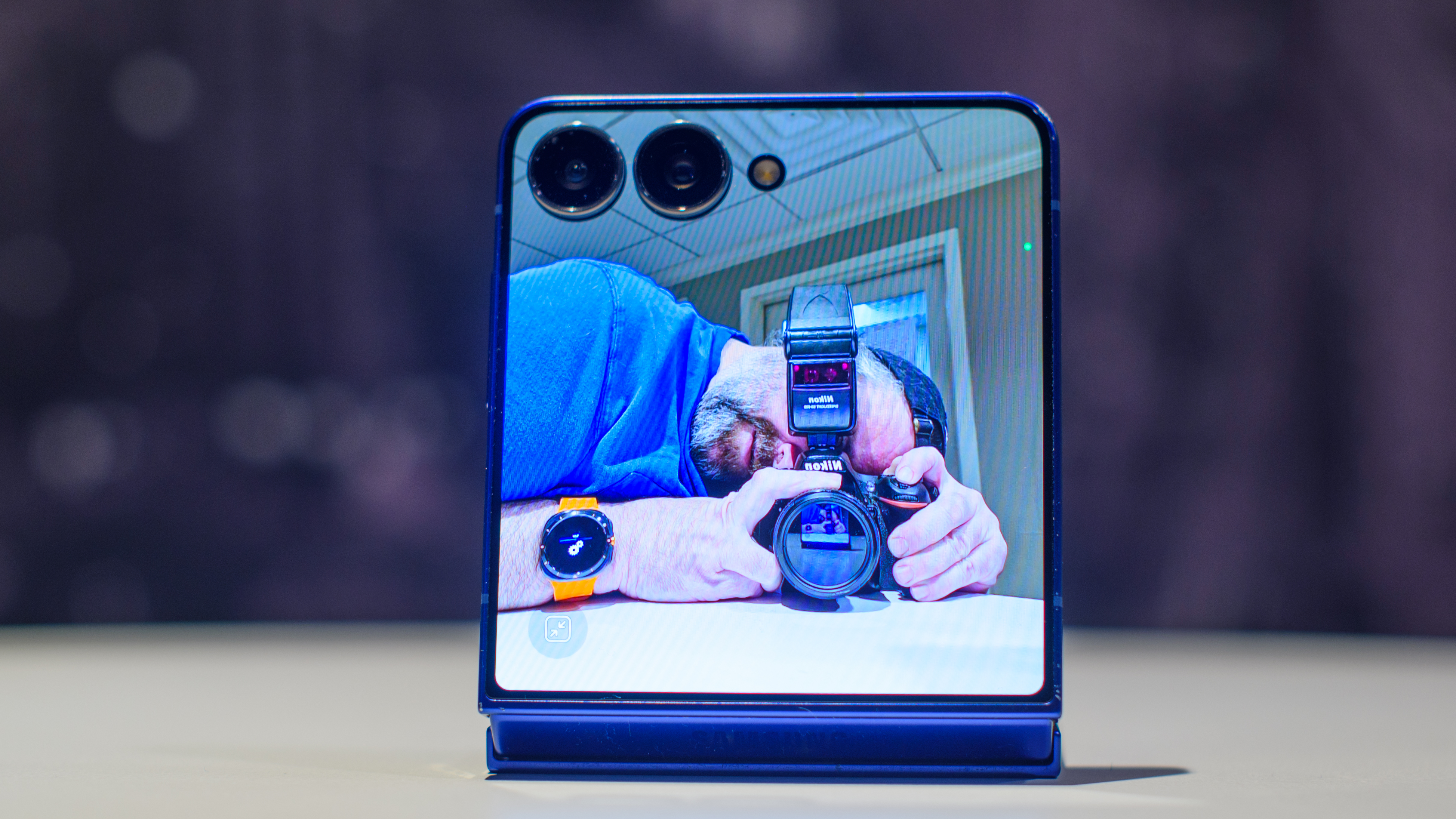 Samsung Galaxy Z Flip 7 in blue with cover display showing me taking a photo of myself