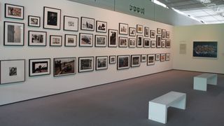 The 'main wall' display of iconic documentary photos at The Camera Never Lies exhibition