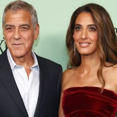 Amal Clooney wore a red velvet mini dress from Oscar de la Renta Fall 2025 at the Jay Kelly premiere