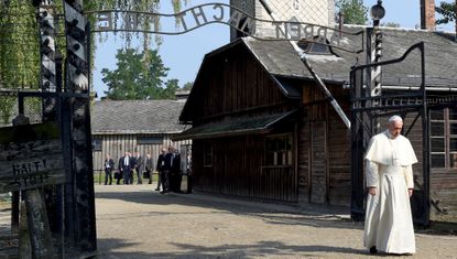 Pope Francis walks the grounds of Auschwitz