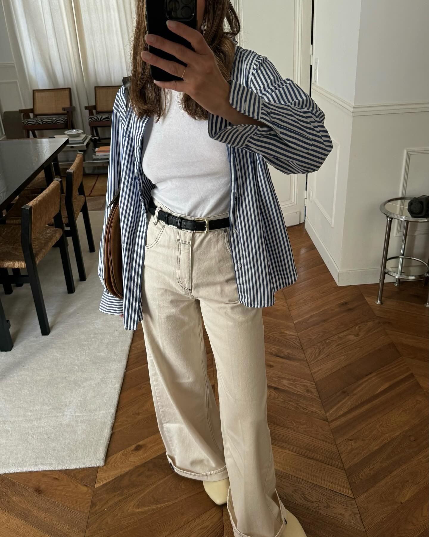 @annelauremais wearing a button-down shirt with a white T-shirt, tan jeans, and tan boots.