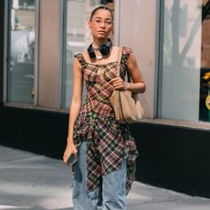 a woman wears ballet flats with jeans