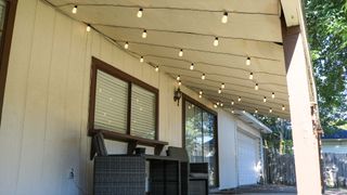 Porch side view with Govee Smart Outdoor String Lights hung up