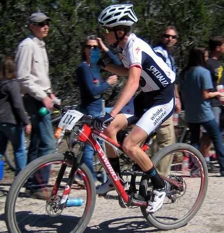 Lucas Newcomb takes a bottle on his way to a podium finish at the Mellow Johnny's Classic.