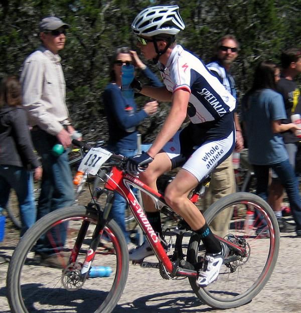 Lucas Newcomb takes a bottle on his way to a podium finish at the Mellow Johnny's Classic.