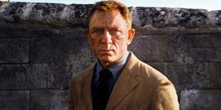 No Time To Die Daniel Craig stands, banged up and angry