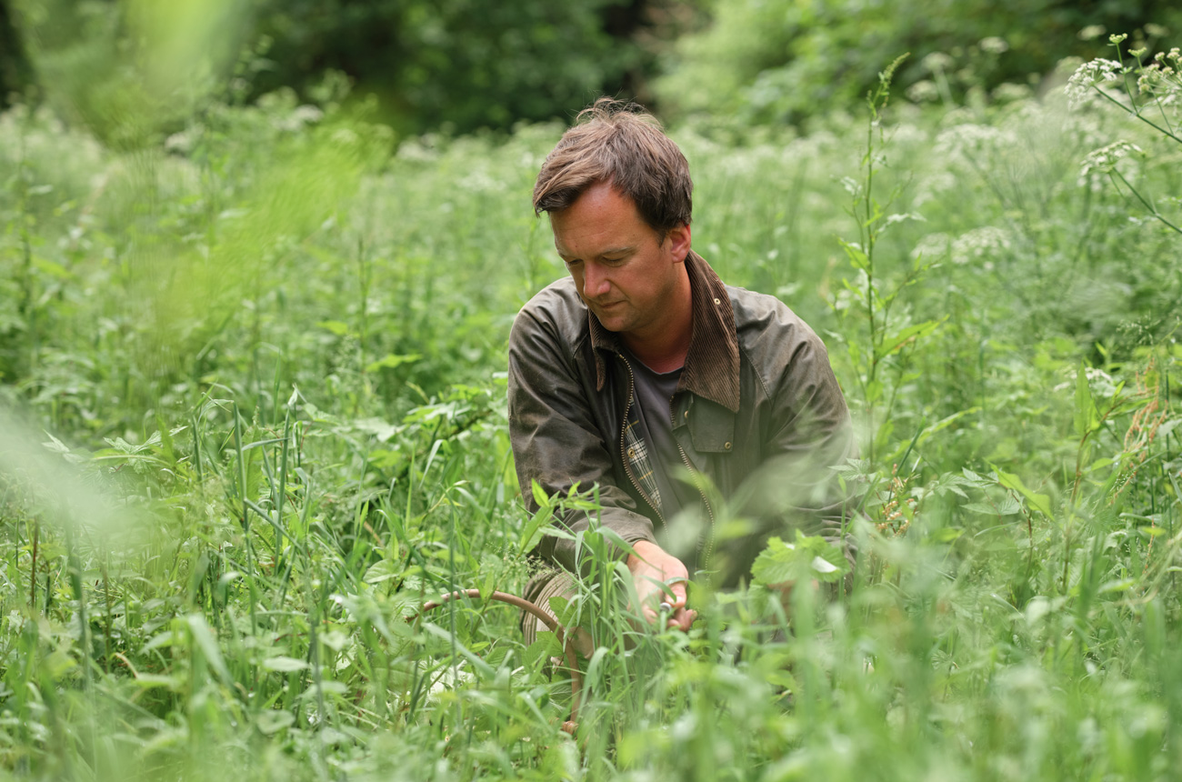 A man kneeling in a field