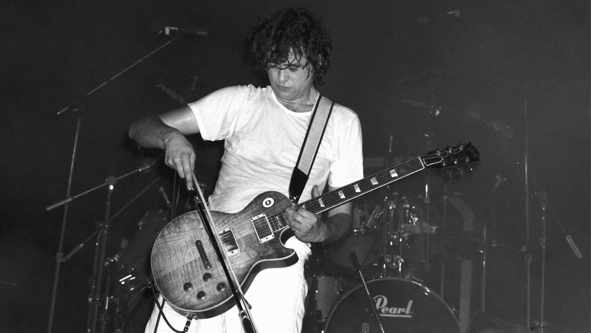 Jimmy Page bows his Les Paul onstage with The Firm.