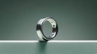 The silver Oura Ring 4 on turquoise surface