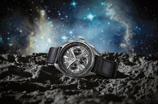 photo illustration of a silver analog watch resting on a mock moon surface, with bright stars and nebulae in the background.