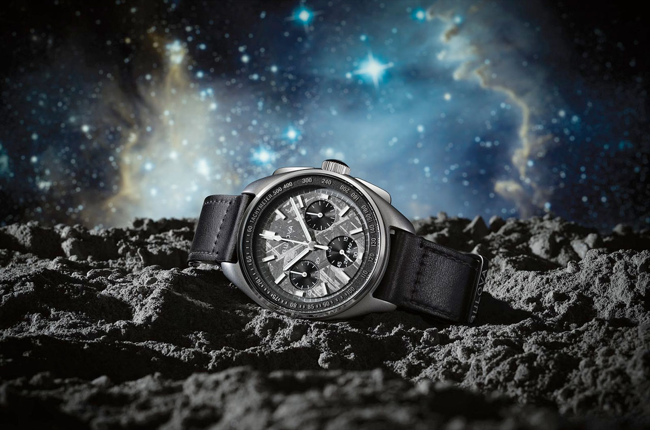 photo illustration of a silver analog watch resting on a mock moon surface, with bright stars and nebulae in the background.