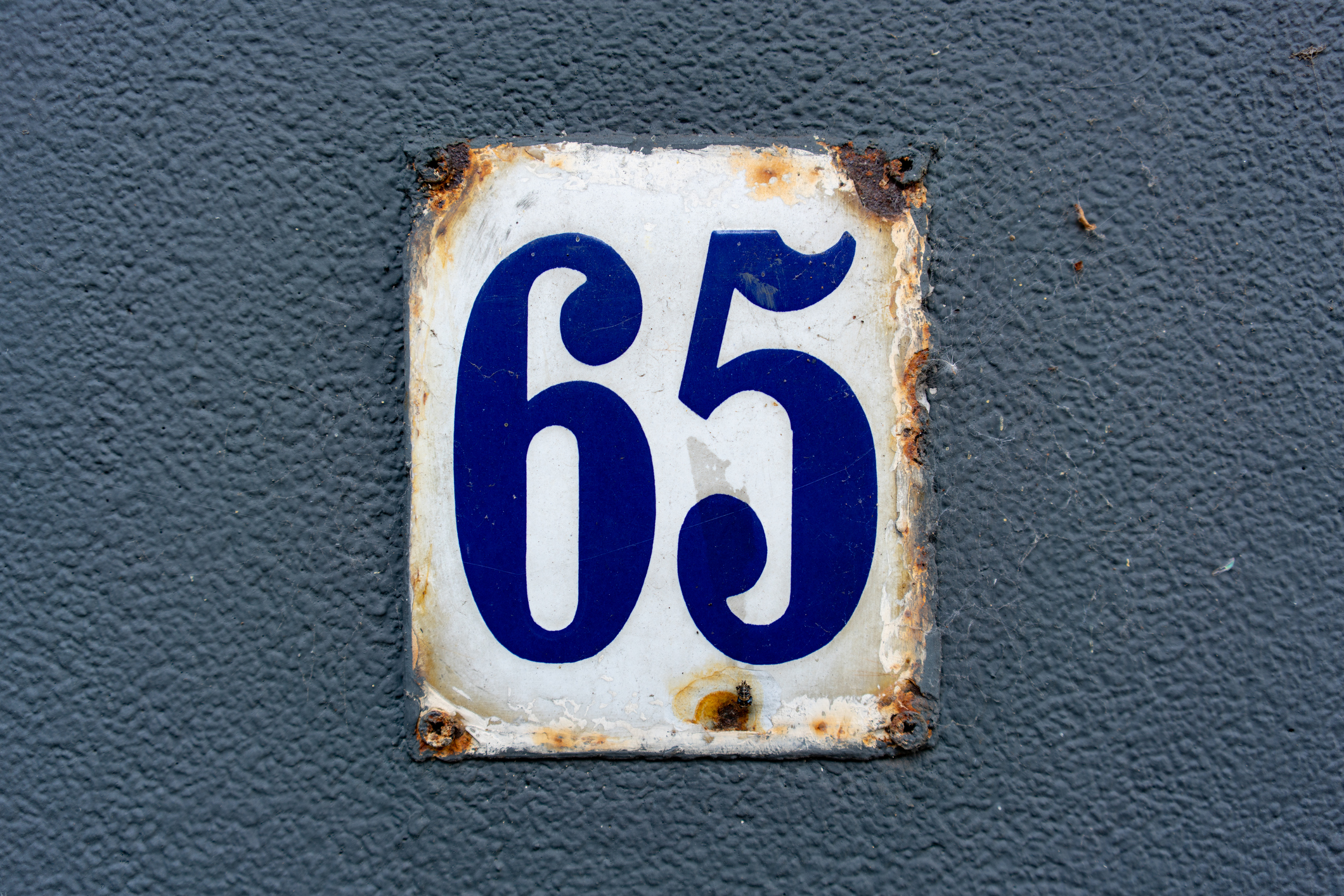 The number 65 on a metal plate