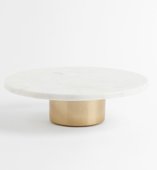 white round cake stand with gold base