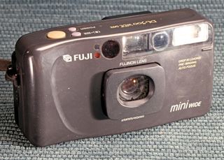 The Fuji DL-500 Travel Mini on a blue background