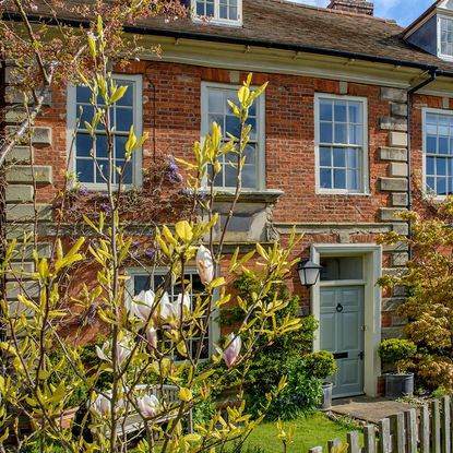 Sunny skies, exterior school house with neat garden