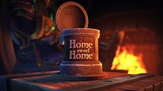 A mug that reads home sweet home sitting on a wooden table in front of a fireplace in World of Warcraft