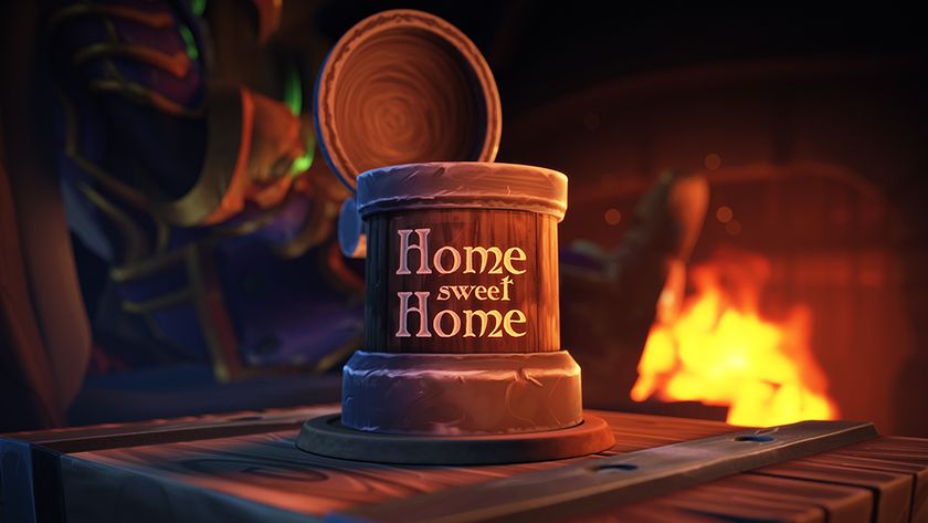 A mug that reads home sweet home sitting on a wooden table in front of a fireplace in World of Warcraft