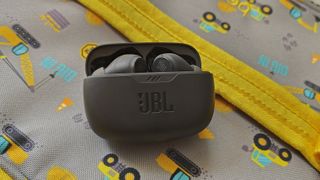 The JBL Vibe Beam sitting on a construction-designed lunch bag