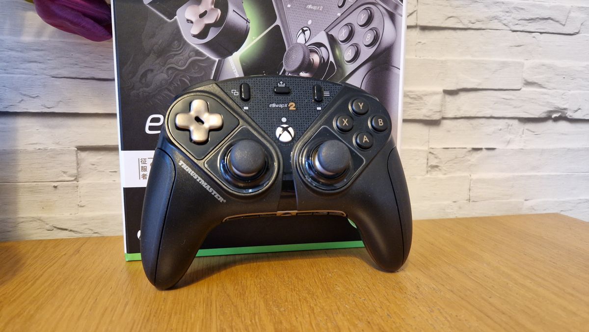 The Thrustmaster eSwap X2 controller on a wooden surface