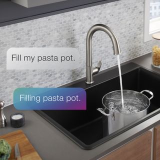 A smart faucet pouring water into a pot