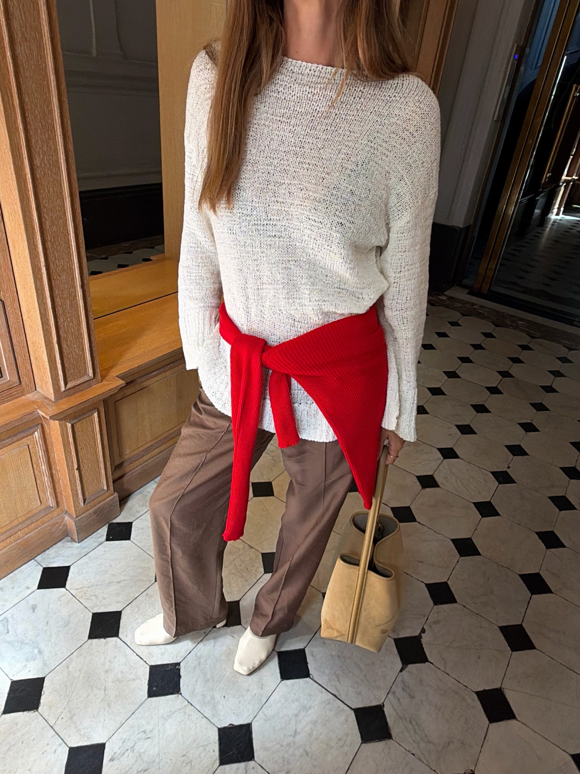 @annelauremais wearing a semi-shirt white swear, red cardigan, trousers, and white heels