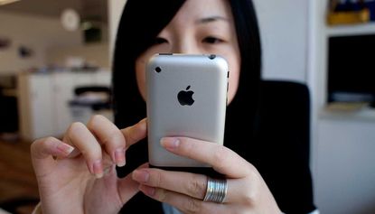 A Chinese iPhone user playing with a phone