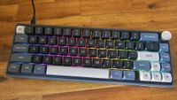 Royal Kludge R65 RGB keyboard on a wood bench
