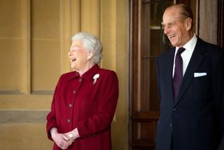 Britain's Queen Elizabeth II and Prince Philip, Duke of Edinburgh react as they bid farewell to Irish President Michael D. Higgins and his wife Sabina