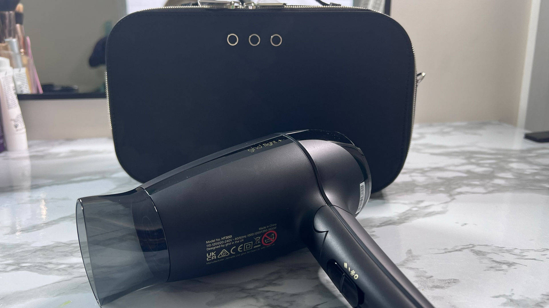 GHD Flight+ hair dryer next to its case