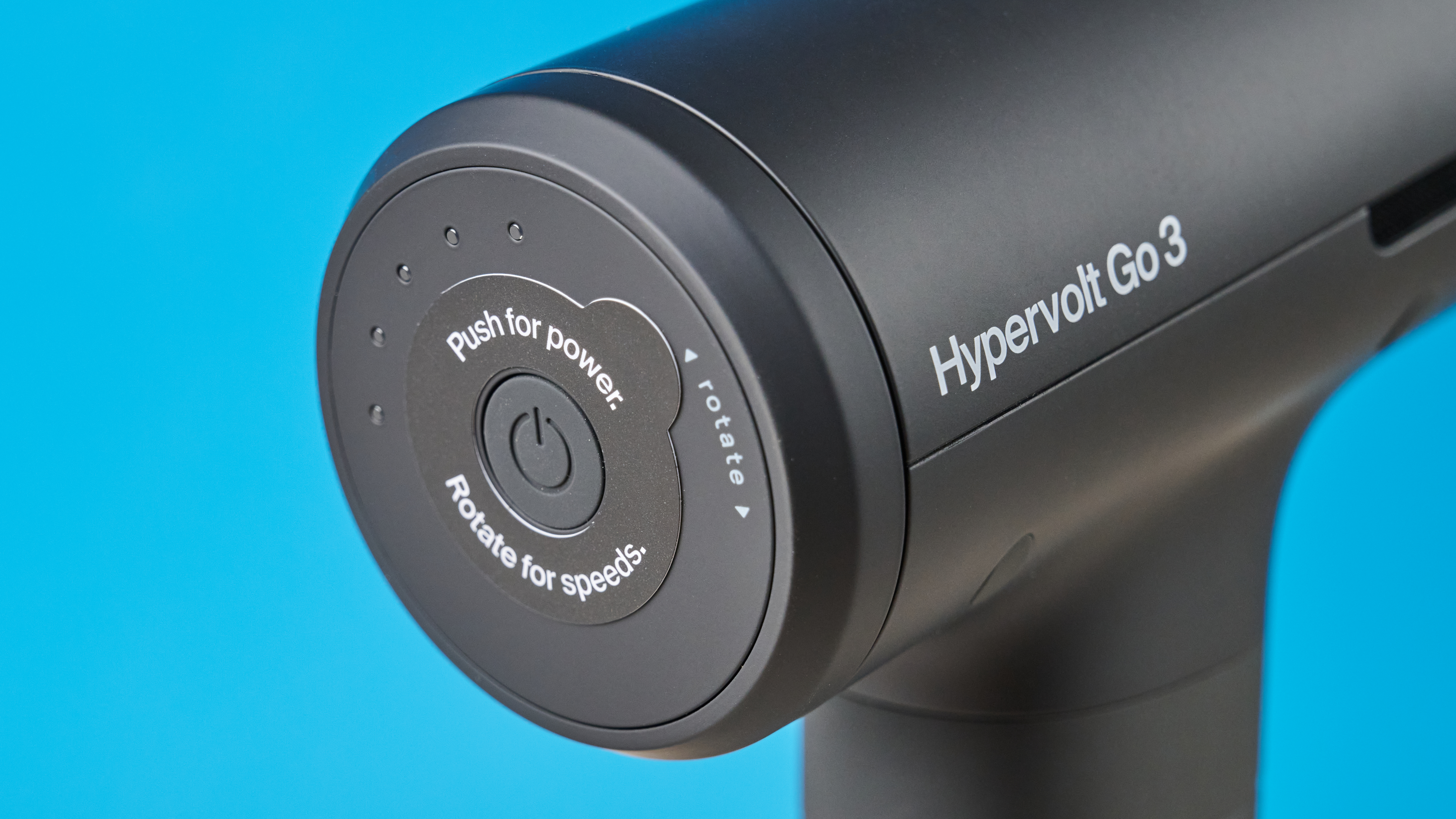 Hyperice Hypervolt Go 3 massage gun photographed in front of a blue background