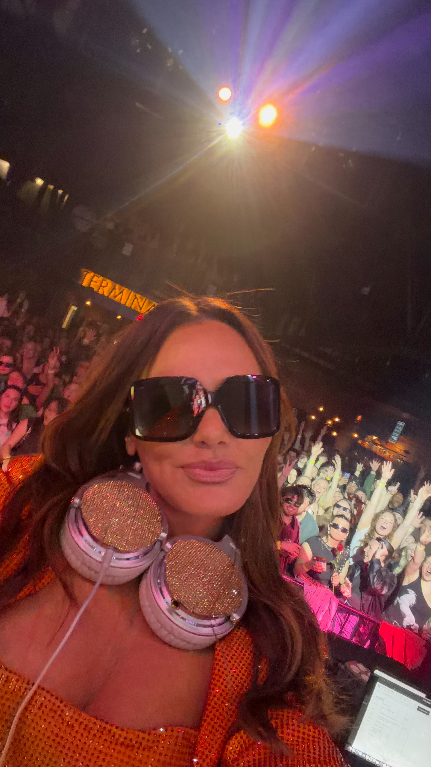 Meredith Marks after her facelift in dark sunglasses in a pink dress in front of a crowd