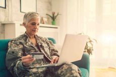 A veteran looking at a laptop.