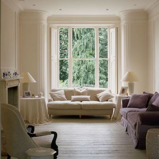 neutral living room with white sofa and lamp