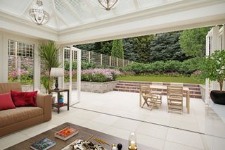 conservatory living space with flooring and patio area