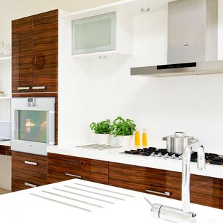kitchen room with white wall and kitchen chimney