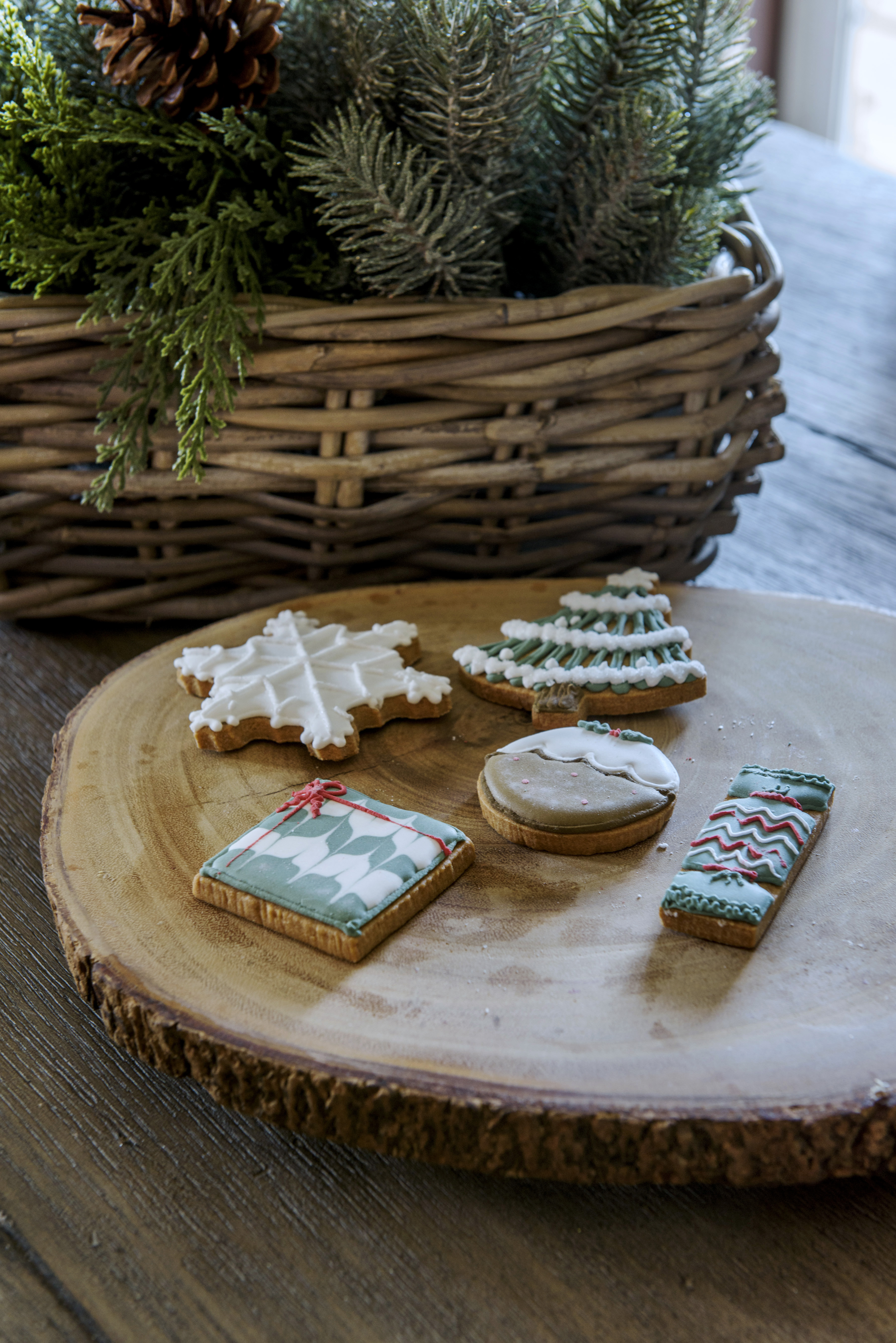 Close up of Christmas decorated biscuits on a wooden board. A 16th century house with five bedrooms and a moat, home of Lynsey and Paul Cross and their family in Essex.