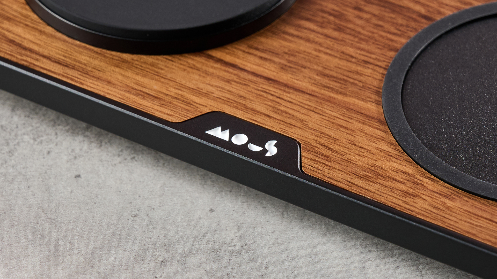 A close-up of the white Mous logo on the front edge of the top of the charger.