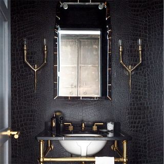 bathroom with crocodile skin textured wall and washbasin with mirror