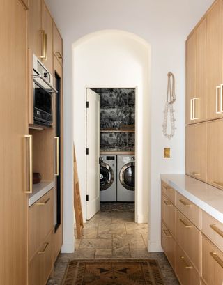 a view through a kitchen to a laundry room