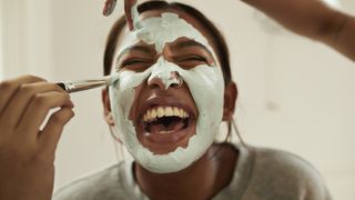 woman applying face mask